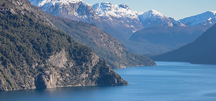 Mountains overlooking a body of water on a beautiful day