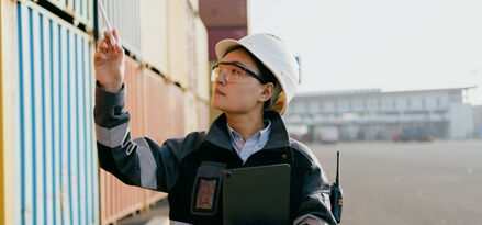 Asian female engineer working at container terminal